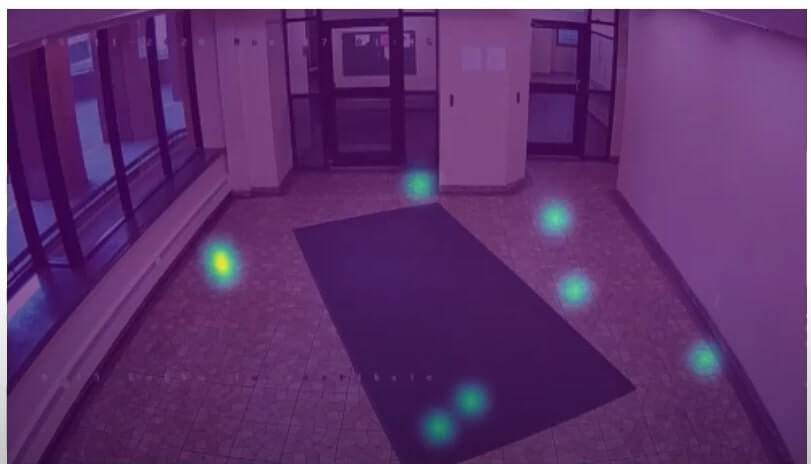 A still of a surveillance video, featuring a heat map that highlights areas of heat with blue and green coloring.