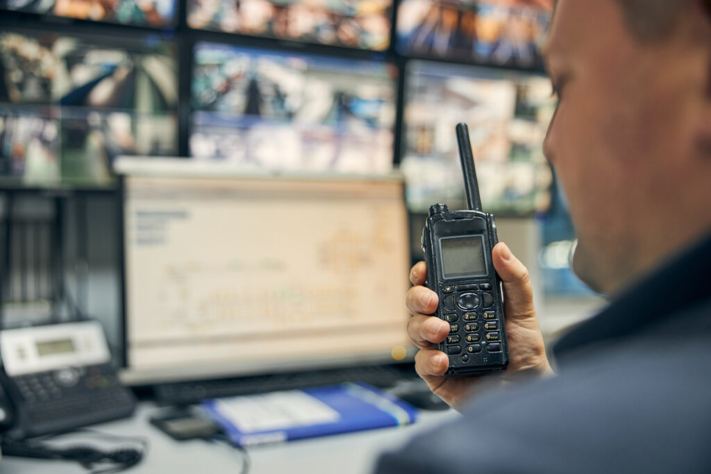 Close-up shot of a walkie-talkie being used for communicating instructions from the control room